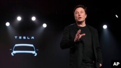 FILE - Tesla CEO Elon Musk speaks before unveiling the Model Y at the company's design studio on March 14, 2019, in Hawthorne, California.