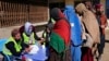 FILE - Afghans register to receive food supplies during a distribution of humanitarian aid for families in need, in Kabul, Afghanistan, Feb. 16, 2022.