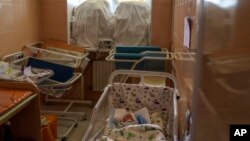 Veronika sleeps in a room fortified with sand bags in the windows at the Pokrovsk Perinatal Hospital in Pokrovsk, Donetsk region, eastern Ukraine, Aug. 15, 2022.
