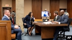 FILE - Fulton County prosecutor Fani Willis, center, and her team are pictured during proceedings to seat a special purpose grand jury in Fulton County, Ga., May 2, 2022, to look into the actions of former President Donald Trump and his supporters.