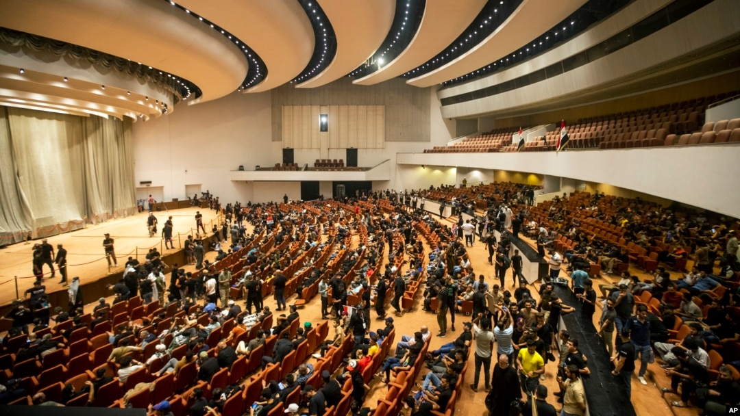 FILE - Followers of Shiite cleric Muqtada al-Sadr fill the parliament hall during a sit-in protest, in Baghdad, Iraq, Aug. 4, 2022. Iraq’s top judicial body said Sunday, Aug. 14, 2022, that it doesn't have the authority to dissolve the country’s parliament.