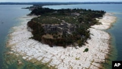 A view of the peninsula of Sirmione on Garda Lake, Italy, Aug. 12, 2022. The lake's water level has dropped critically amid severe drought resulting in rocks to emerge around the peninsula. 