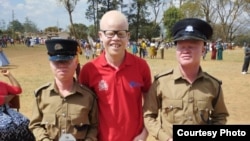 Hamid Vasco (right) and Brenda Mhlanga (left) pose with former APAM president Ian Simbota after Police Training School in Blantyre, Malawi, Aug. 26, 2022.