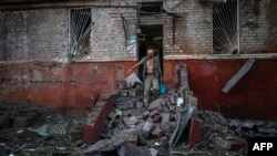 FILE - A man leaves his damaged apartment building following a missile strike in Kramatorsk, Donetsk region, Ukraine, Aug. 31, 2022, amid the Russian invasion of Ukraine.
