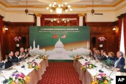 A delegation of U.S. Congress members, at right, toasts with the Taiwanese side during a welcome banquet at the Taipei Guest House in Taipei, Taiwan, Aug. 15, 2022. (Taiwan Ministry of Foreign Affairs via AP)