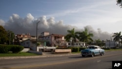 Smoke rises from a deadly fire at a large oil storage facility in Matanzas, Cuba, August 9, 2022. The fire was sparked by lightning that struck one of the facility’s eight tanks on August 5. 