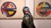 A visitor looks at artworks of the American artist Frank Stella, Sinjerli Variations No. 1-5- 1977, while visiting a 19th and 20th-century American and European minimalist and conceptual masterpieces show at the Tehran Museum of Contemporary Art in Tehran