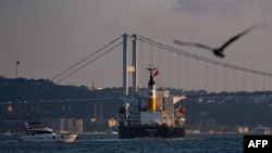 The Panama-flagged bulk carrier Navi Star carrying tons of grain from Ukraine sails along the Bosphorus Strait past Istanbul on Aug. 7, 2022, after being officially inspected. 