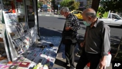 People scan publications at a news stand in Tehran, Iran, Aug. 13, 2022.