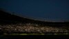 FILE - Fans use their phone lights during an electricity black out causing a delay to the kick-off of the UEFA Nations League the UEFA Nations League football match Austria vs Denmark in Vienna, Austria on June 6, 2022.