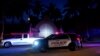 FILE - A supporter of former President Donald Trump drives past his Mar-a-Lago estate, Aug. 8, 2022, in Palm Beach, Florida, as the FBI conducts a search of the residence. 
