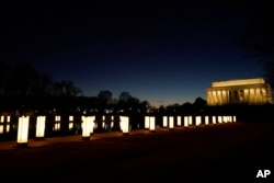 En la antesala de la inaguración presidencial la piscina reflectora del Lincoln Memorial fue iluminada para el homenaje al personal médico y los cientos de miles víctimas de Covid-19 que habían perecido hasta enero de 2021 en Estados Unidos.