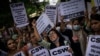 Activists shout slogans against the remission of sentence by the government to convicts of a gang rape, in New Delhi, India, Aug. 18, 2022. A Muslim woman who was gang raped in 2002 has appealed the decision to free the 11 men jailed for life for committi