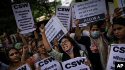 Activists shout slogans against the remission of sentence by the government to convicts of a gang rape, in New Delhi, India, Aug. 18, 2022. A Muslim woman who was gang raped in 2002 has appealed the decision to free the 11 men jailed for life for committi