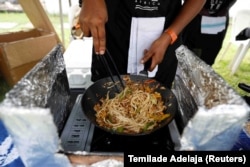 Chaks prepares gluten-free pasta made from cassava for a customer at the Farmers Market in Ikoyi, Lagos, Nigeria on June 25, 2022.