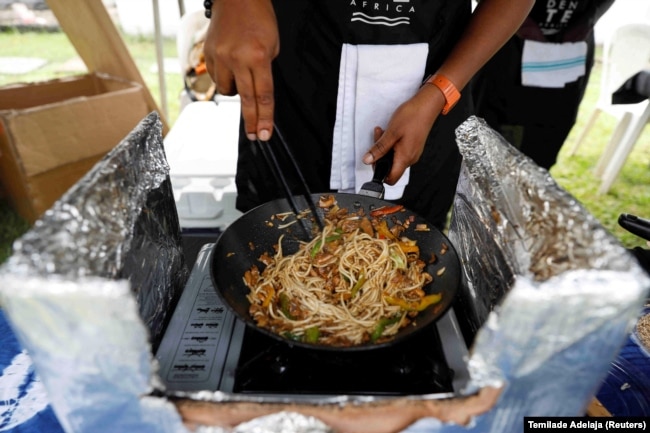 Chuks cooks gluten-free pasta made of cassava for a customer during a weekly farmers' market in Ikoyi, Lagos, Nigeria June 25, 2022.