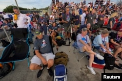 FILE - Spectators wait for the launch of NASA's next-generation moon rocket, the Space Launch System, with its Orion crew capsule on top, on the unmanned Artemis 1 mission, which was later scrubbed, at Cape Canaveral, Florida, U.S., August 29, 2022.