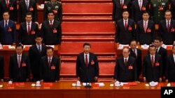 FILE - Chinese President Xi Jinping and his cadres sing the Communist song during the closing ceremony for the 19th Party Congress held at the Great Hall of the People in Beijing on Oct. 24, 2017.