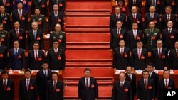 FILE - Chinese President Xi Jinping and his cadres sing the Communist song during the closing ceremony for the 19th Party Congress held at the Great Hall of the People in Beijing on Oct. 24, 2017.