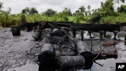 FILE - An abandoned illegal oil refinery is seen at the creeks of Bayelsa, Nigeria, May 18, 2013.