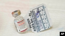 FILE: A vial of the Pfizer COVID-19 vaccine. New data from Pfizer and BioNTech show their tot-sized COVID-19 vaccine was 73% effective in protecting children younger than 5. Taken June 21, 2022