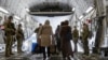 In this image provided by the Australian Defense Force, Aug. 22, 2021, Afghanistan evacuees arrive at Australia's main operating base in the Middle East, on board a Royal Australian Air Force C-17A Globemaster. (LACW Jacqueline Forrester/Australian Defens