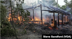 A village hut burns to the ground in Rakhine in September 2017.