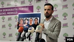 HDP Deputy Huseyin Kacmaz holding the photos of the teenagers killed in Turkish airstrikes