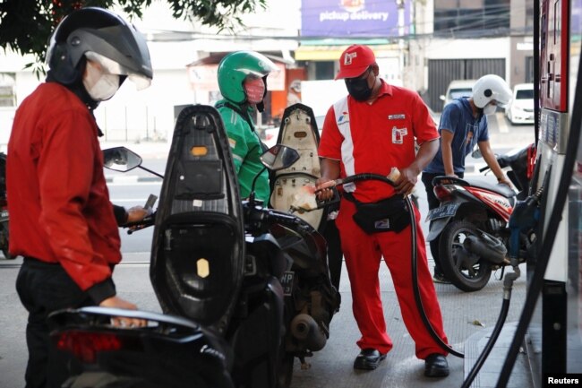 Pekerja SPBU Pertamina mengisi sepeda motor dengan bensin bersubsidi di Jakarta, 22 Agustus 2022. (REUTERS/Ajeng Dinar Ulfiana)