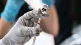 FILE - A pharmacist loads a syringe with monkeypox vaccine at a pop-up vaccination site in West Hollywood, California, Aug. 3, 2022.