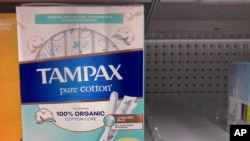 Tampons are seen on a shelf at a pharmacy store in Wheeling, Ill., June 30, 2022. The only Tampa factory in the US pays $25 an hour still can't hire enough workers, as tampon and labor shortages collide. 