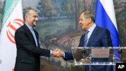 Russian Foreign Minister Sergey Lavrov, right, and Iranian Foreign Minister Hossein Amir-Abdollahian shake hands after a joint news conference following their talks in Moscow, Russia, Aug. 31, 2022. 