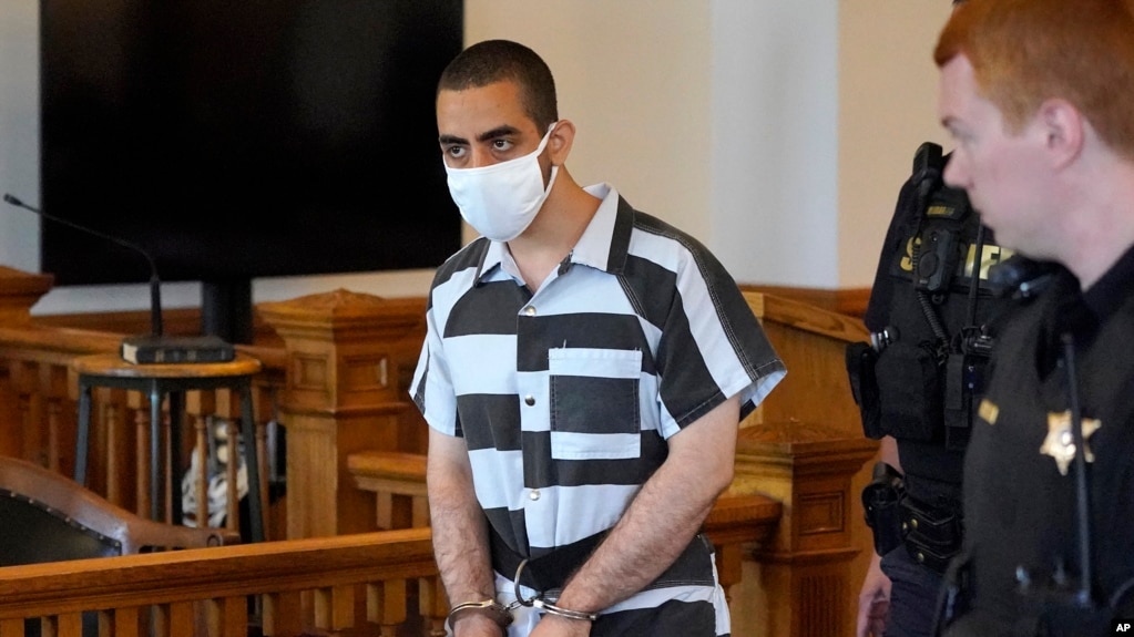 FILE - Hadi Matar, 24, center, the accused attacker of author Salman Rushdie, arrives for an arraignment in the Chautauqua County Courthouse in Mayville, New York, Aug. 13, 2022.
