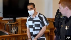 FILE - Hadi Matar, 24, center, the accused attacker of author Salman Rushdie, arrives for an arraignment in the Chautauqua County Courthouse in Mayville, New York, Aug. 13, 2022.
