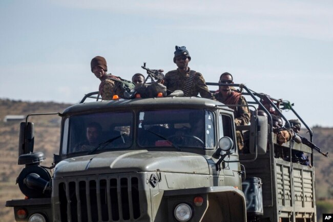 FILE - Ethiopian government soldiers ride in the back of a truck on a road near Agula, north of Mekelle, in the Tigray region of northern Ethiopia on May 8, 2021. (AP Photo/Ben Curtis, File)