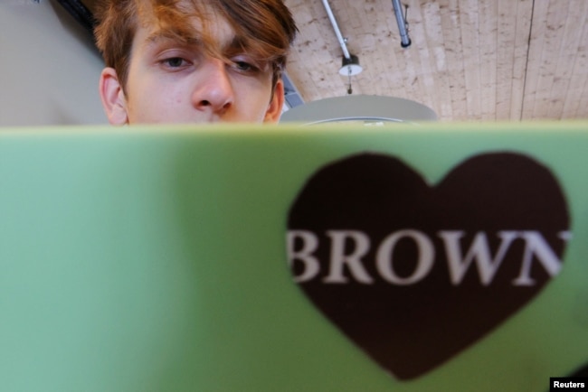 Hlib Burtsev, who is from Ukraine, reads his email in the common area outside his dorm room ahead of his first year at Brown University in Providence, Rhode Island, U.S., August 16, 2022. (REUTERS/Brian Snyder)