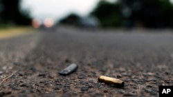 In this Oct. 16, 2019 photo spent bullet casings litter the site where a convoy of Michoacan state police were ambushed and slaughtered by Jalisco cartel gunmen, in El Aguaje, Mexico. 