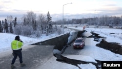 FILE - A stranded vehicle lies on a collapsed roadway near the airport after an earthquake in Anchorage, Alaska, U.S. Nov. 30, 2018.