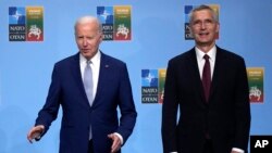 NATO Secretary General Jens Stoltenberg, right, greets United States President Joe Biden during arrivals for a NATO summit in Vilnius, Lithuania, Tuesday, July 11, 2023.