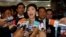 FILE - Thailand's former prime minister, Yingluck Shinawatra, talks to reporters at parliament in Bangkok, Jan. 9, 2015. 