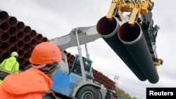 FILE - Steel pipes for the North Stream 2 pipeline are uploaded in Mukran harbour in Sassnitz, Germany, May 8, 2017. 