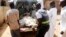 Security officials evacuate victims of a bomb attack at St. Rita's Catholic church in the Malali village in Nigeria's northern city of Kaduna, Oct. 28, 2012.