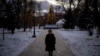 A woman walks near an illuminated Christmas tree, in Kyiv, amid Russia's attack on Ukraine, Dec. 12, 2024.