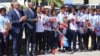 Haitian President Jovenel Moise, third from left, and Prime Minister Jacques Guy Lafontant, second from left, greet the U-20 women's team at Toussaint Louverture International Airport in Port-au-Prince with flowers, handshakes and praise for job well done, Jan. 30, 2018. (FHF photo) 