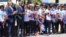 Haitian President Jovenel Moise, third from left, and Prime Minister Jacques Guy Lafontant, second from left, greet the U-20 women's team at Toussaint Louverture International Airport in Port-au-Prince with flowers, handshakes and praise for job well done, Jan. 30, 2018. (FHF photo) 