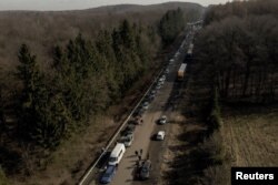 A screen grab from drone footage shows cars forming a line that stretches some 35 km from the Shehyni border crossing to Poland as people try to flee Russia's military operation against Ukraine, outside Mostyska, Ukraine, Feb. 26, 2022.