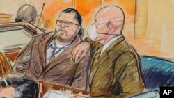 This artist sketch depicts Guy Wesley Reffitt, joined by his lawyer William Welch, right, in Federal Court, in Washington, Feb. 28, 2022. Reffitt is the first Jan. 6 defendant to go on trial.