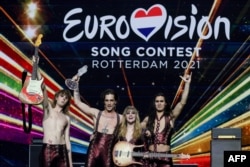 FILE - Italy's Maneskin celebrate after winning the 65th edition of the Eurovision Song Contest 2021, at the Ahoy convention centre in Rotterdam, May 22, 2021.