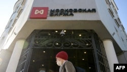 A man walks past the Moscow's stock market building in downtown Moscow on Feb. 28, 2022