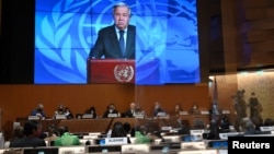 U.N. Secretary-General Antonio Guterres appears on a screen as he delivers a speech at the opening of a session of the U.N. Human Rights Council, following the Russian invasion in Ukraine, in Geneva, Switzerland, Feb. 28, 2022.